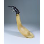 A North-West Coast Carved Horn Ladle of two-piece form, the black handle carved with animal