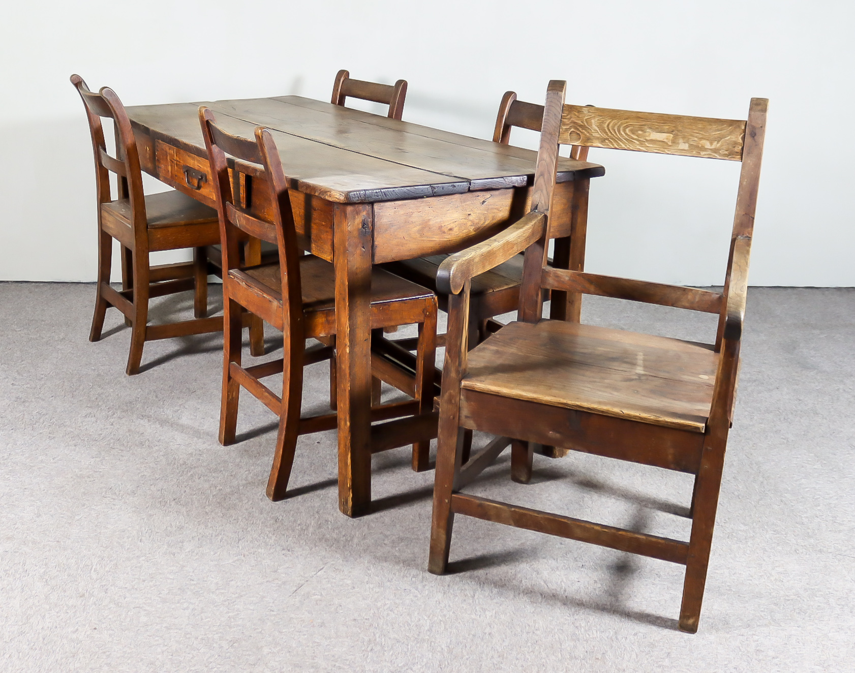 A 19th Century Elm Rectangular Kitchen Table and a Set of Five Ash Dining Chairs, the table with