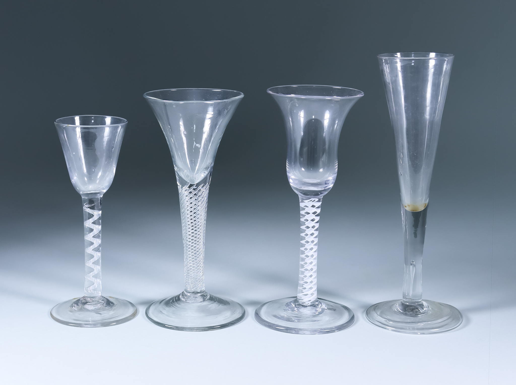 Four Drinking Glasses, 18th Century, including - a wine glass with bell-shaped bowl on a double