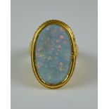 An Opal Doublet Dress Ring, Modern, yellow metal ring set with a oval opal doublet, size L, gross