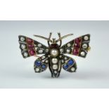 A Diamond, Sapphire and Ruby Brooch, Late 19th/ Early 20th Century, yellow and silver metal set with