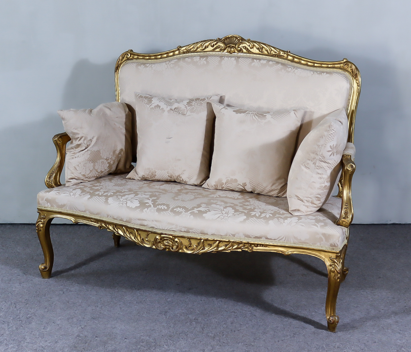 An Early 20th Century French Gilt Framed Two Seat Settee of "Louis XV" Design, with leaf carved