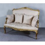 An Early 20th Century French Gilt Framed Two Seat Settee of "Louis XV" Design, with leaf carved