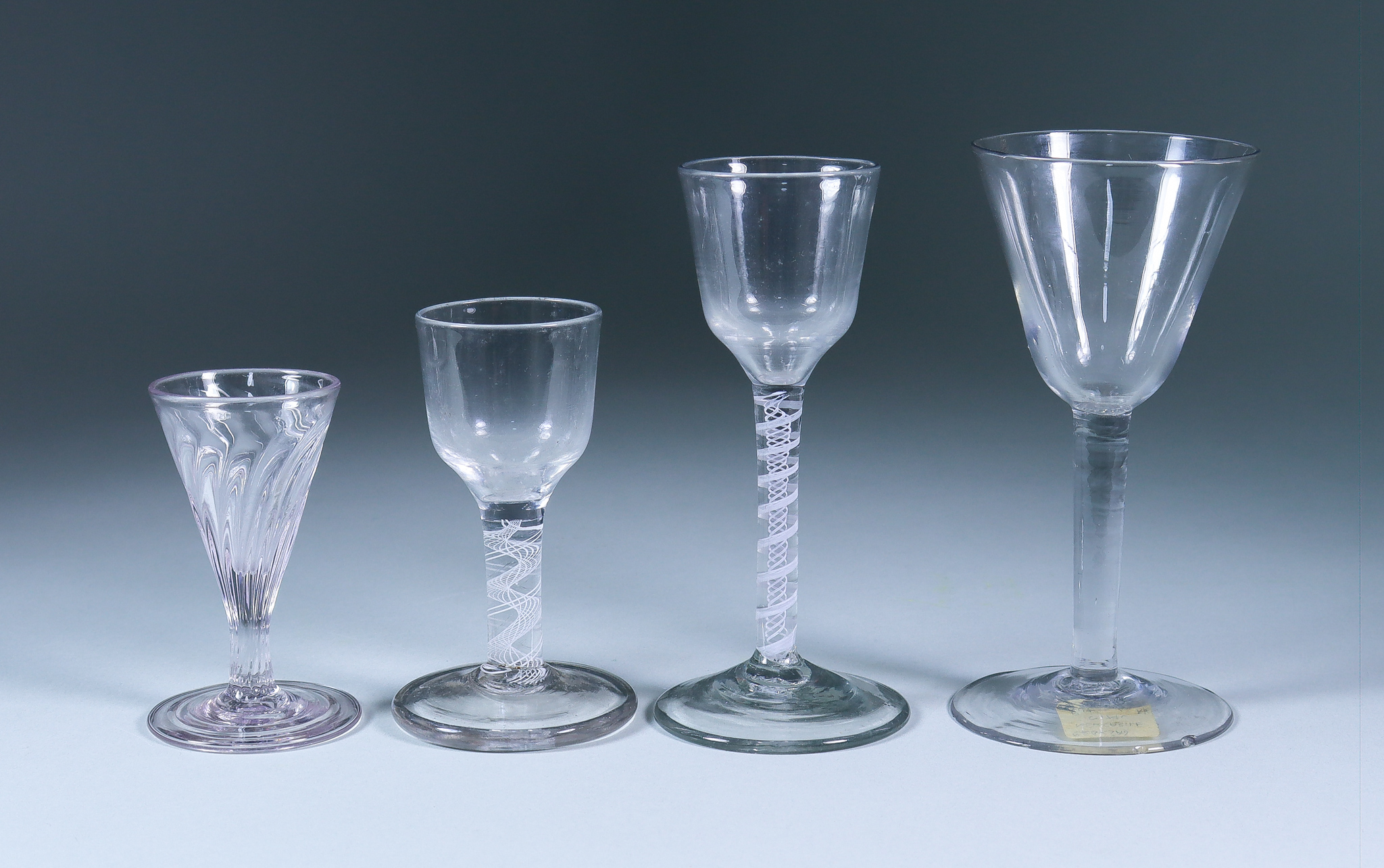 Four Drinking Glasses, 18th Century, including - wine glass with plain bell-shaped bowl on a plain