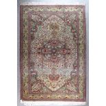 An Early 20th Century Kayseri Carpet, woven in muted colours with a bold central flower head