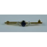 A Sapphire and Diamond Bar Brooch set with a centre sapphire stone, approximately .50ct, flanked