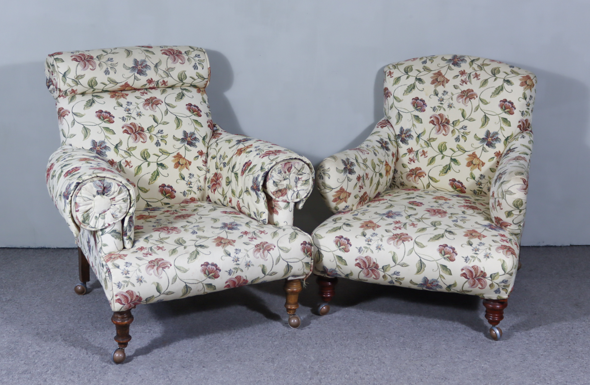 Two Victorian Easy Chairs in the Manner of Howard, upholstered in patterned cloth, on turned legs