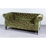A Victorian Three Seat Drop End Settee with scroll ends, upholstered in leaf pattern moquette, on