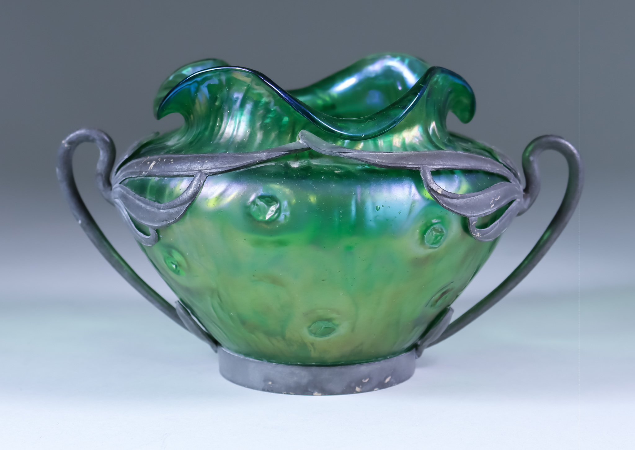 A Loetz Green Iridescent Glass Vase with Van Houten Pewter Frame, Circa 1900, the mount indistinctly