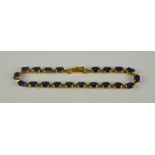 A 10ct Gold Sapphire Line Bracelet, Modern, set with twenty faceted sapphires, approximately 10ct in