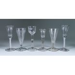 Six Drinking Glasses, 18th Century, including - a pair of wine glasses with bell bowls, plain cotton