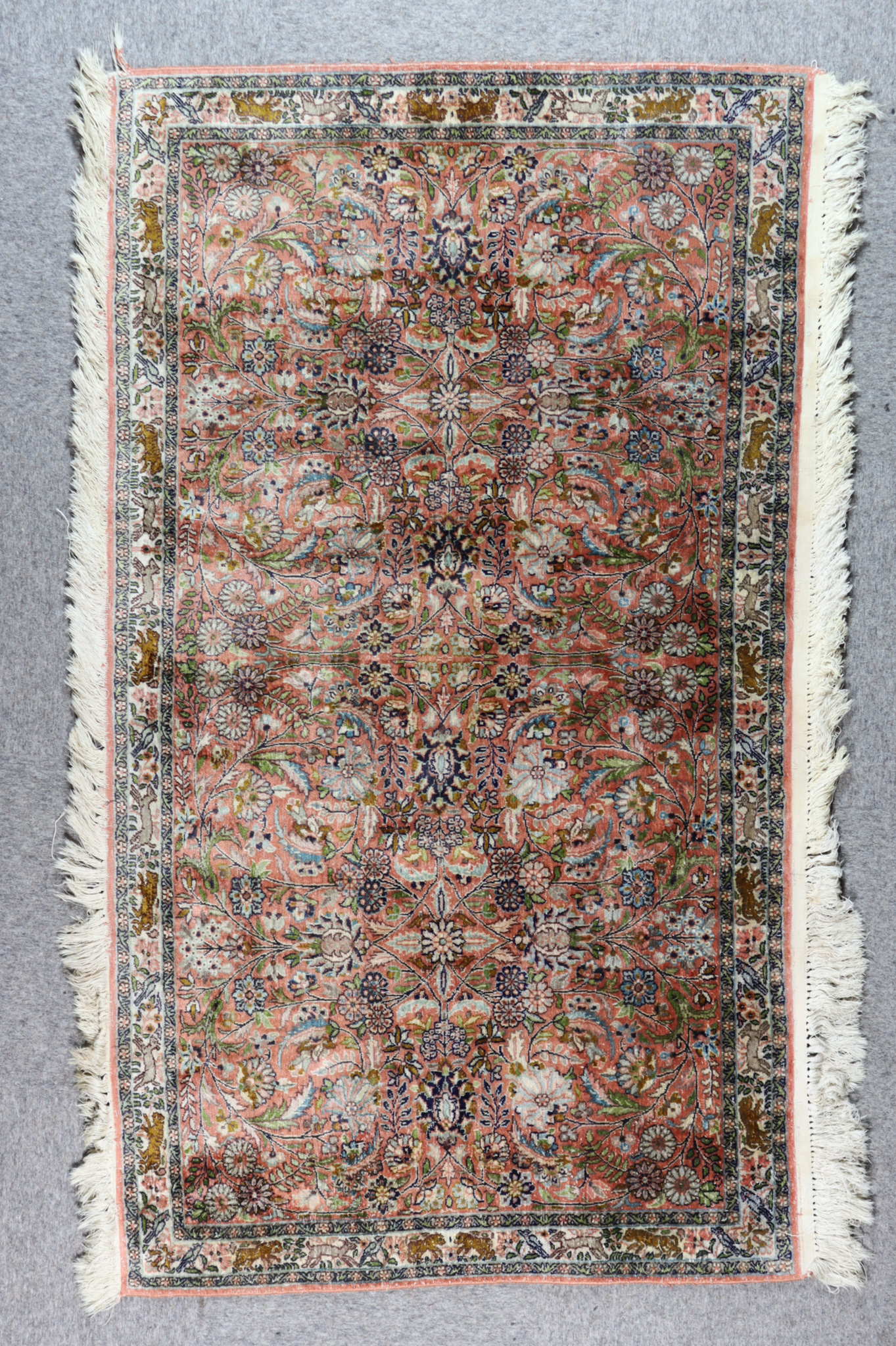 An Early 20th Century Fine Isfahan Silk Rug, woven in pastel colours, with three lozenge shaped