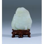 A Chinese Pale Celadon Pendant, 18th Century, carved with fungus and pomegranate, 1.75ins (4.5cm)