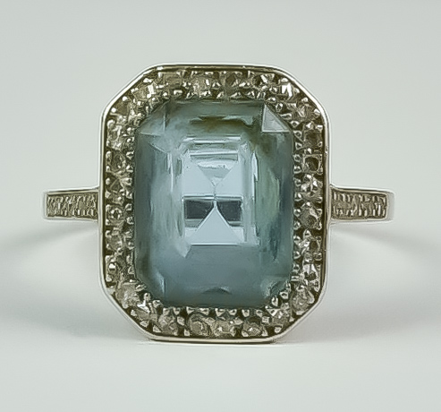 An Aquamarine and Diamond Ring, Early 20th Century, white metal set with a centre aquamarine