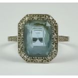 An Aquamarine and Diamond Ring, Early 20th Century, white metal set with a centre aquamarine