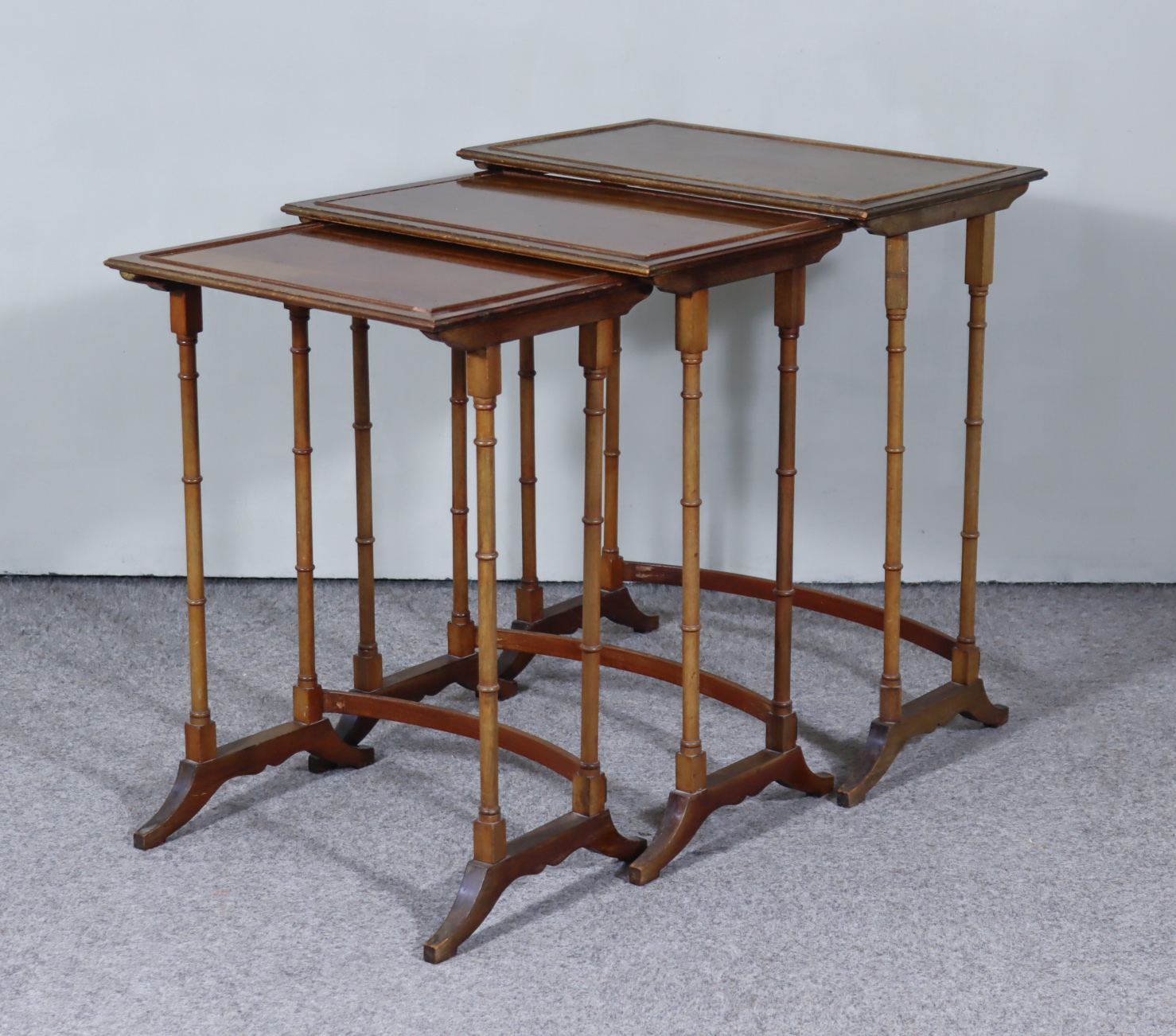 A Nest of Three Mahogany Rectangular Occasional Tables of "George III" Design, on slender turned