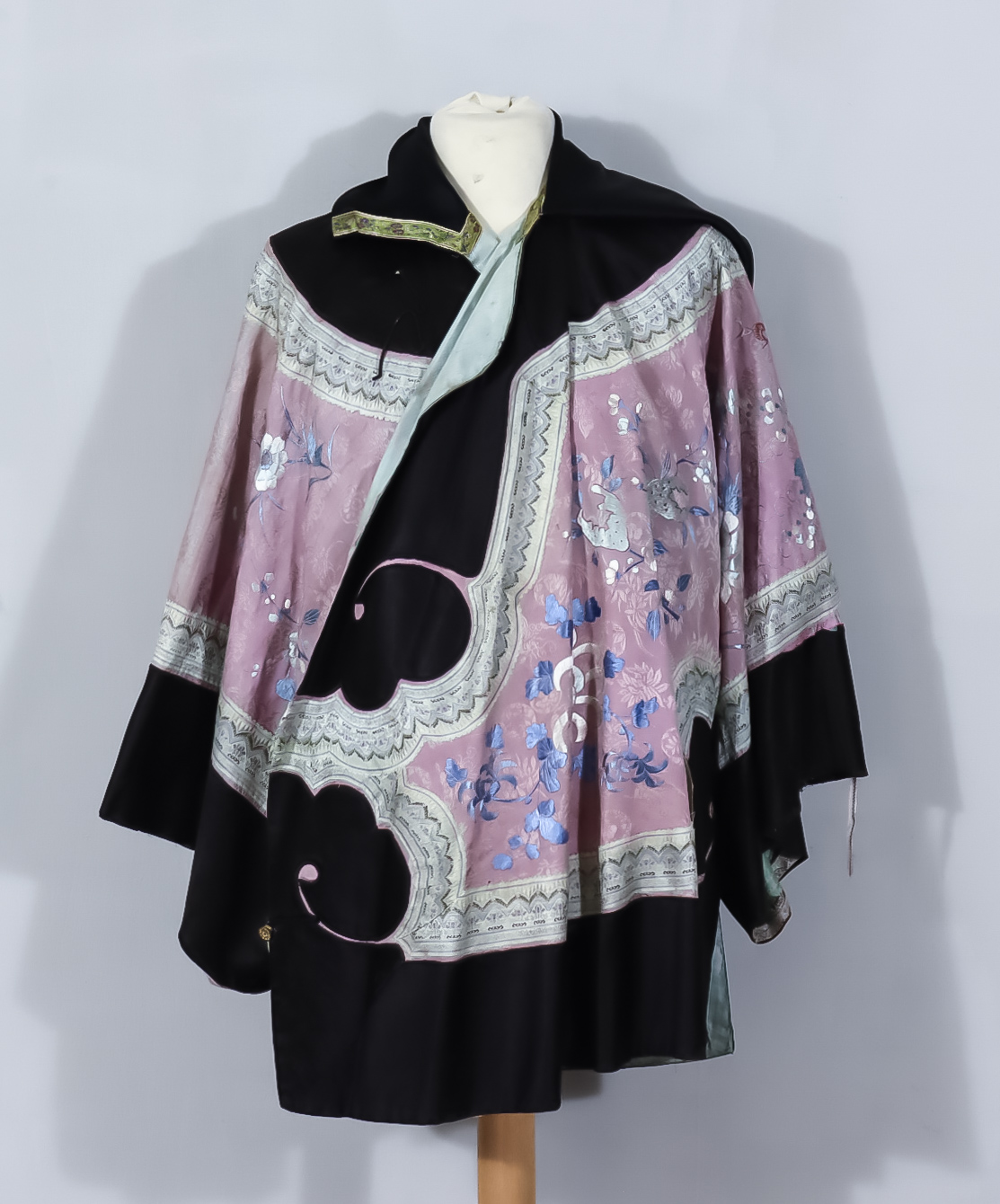 A Chinese Silk Robe, Early 20th Century, worked in coloured silks with flowering branches and