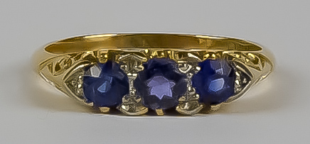 A Sapphire and Diamond Ring, Modern, 18ct gold, set with three sapphires, approximately .75ct,