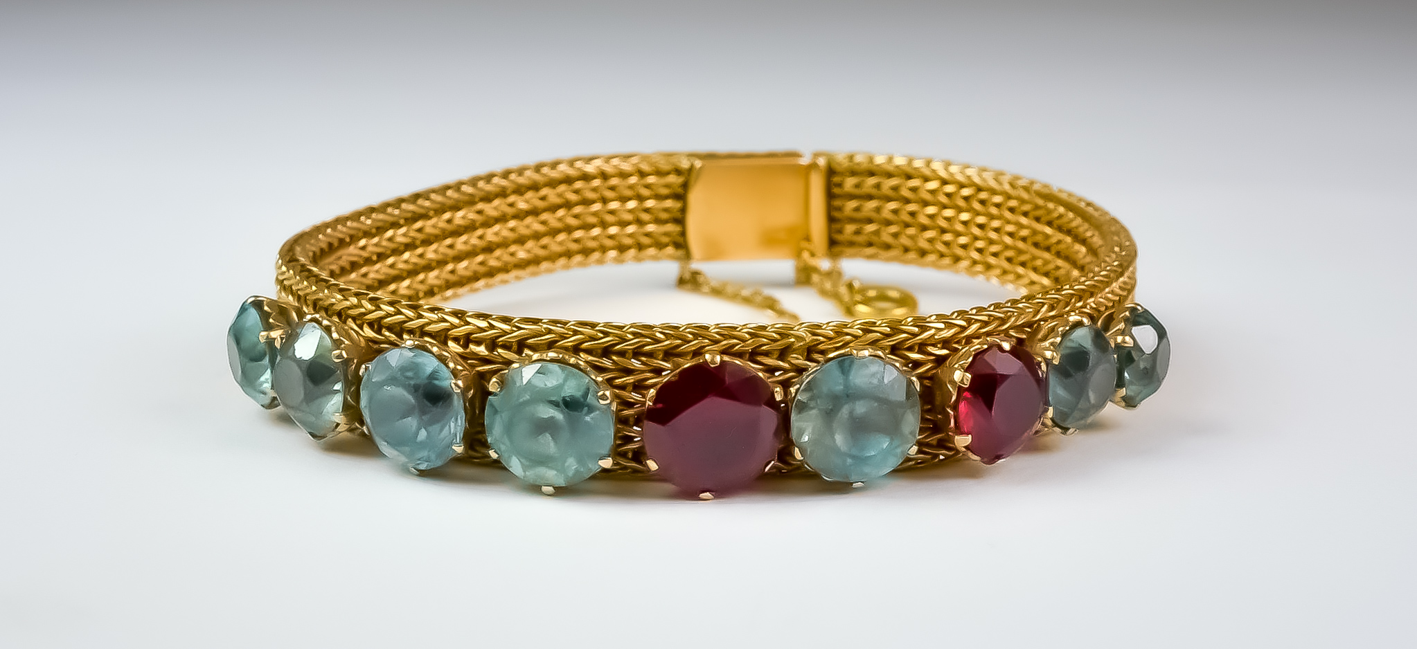 A Lady's Gem Set Milanese Bracelet, 20th Century, 18ct gold milanese bracelet set with seven blue