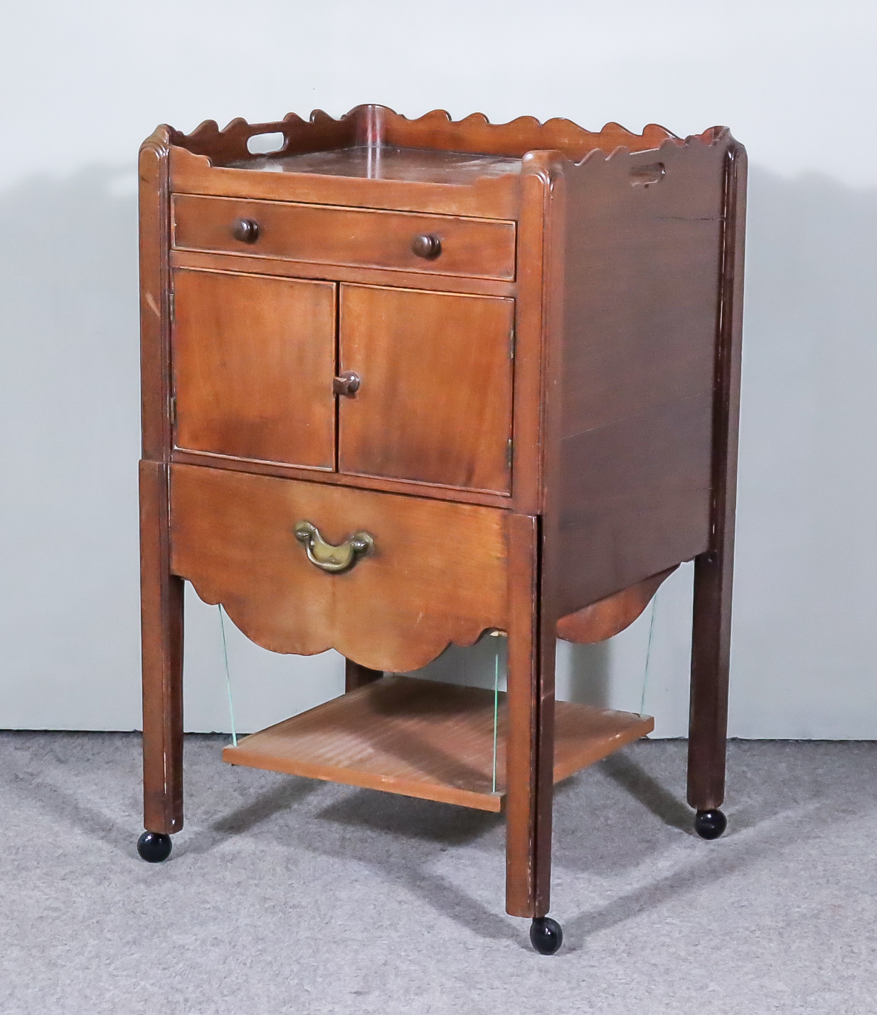 A George III Mahogany Tray Top Bedside Cabinet, with shaped edge with handle cut outs, fitted one