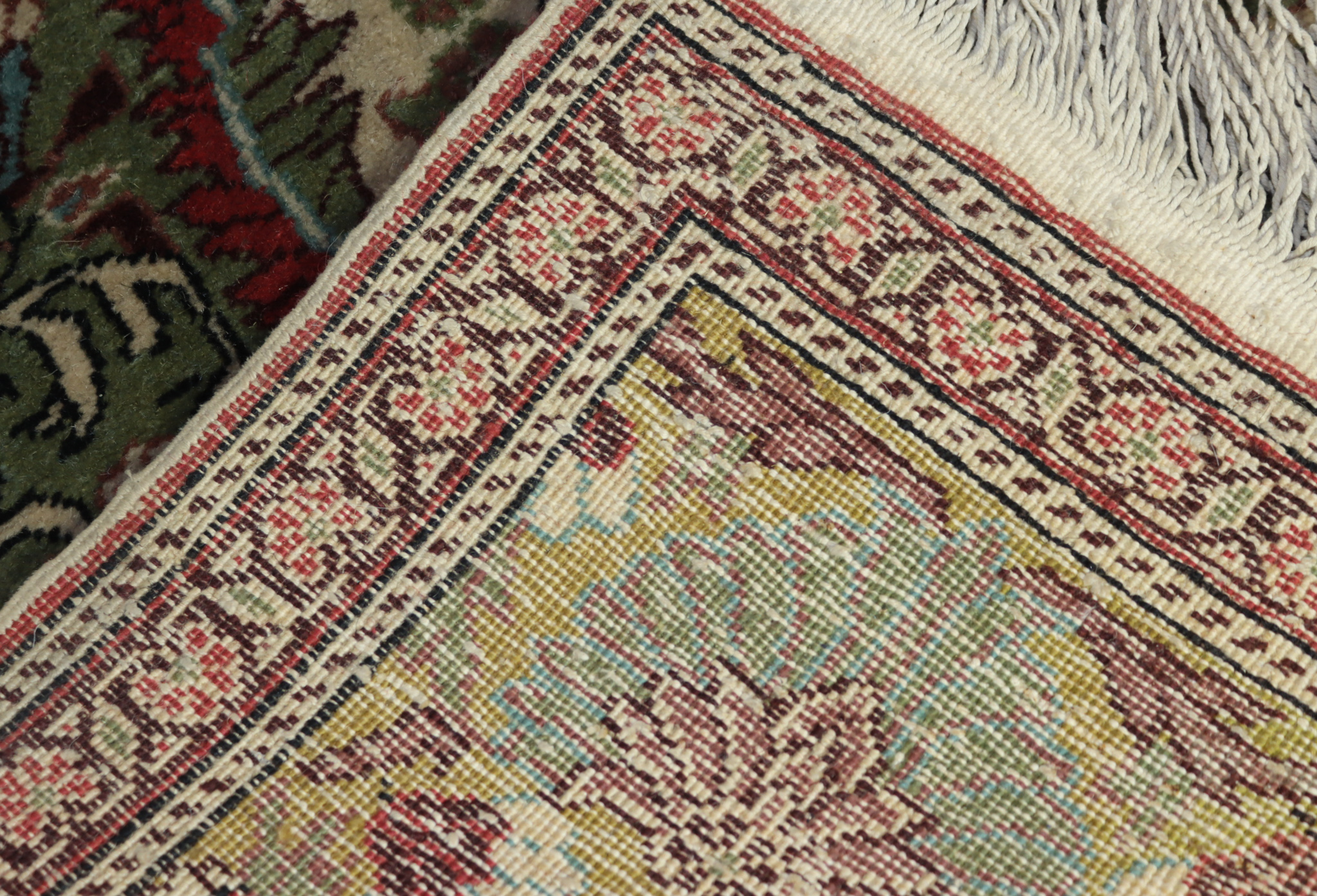 An Early 20th Century Kayseri Carpet, woven in muted colours with a bold central flower head - Image 2 of 2