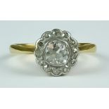 A Diamond Flower Head Ring, 20th Century, 18ct gold set with a centre diamond. approximately .