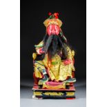 A Large Chinese Carved Polychrome and Giltwood Seated Figure of a Bearded Deity, with elaborate