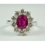 A Ruby and Diamond Ring, Modern, in 18ct white gold mount set with a central faceted ruby,