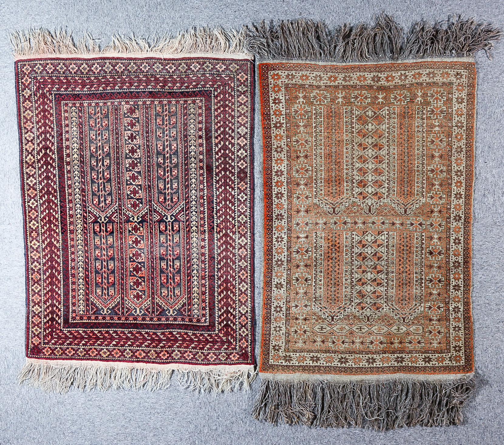 A Mid-20th Century Turkmen Enzi Rug, woven in navy blue, wine and fawn, with panels of hooked motifs