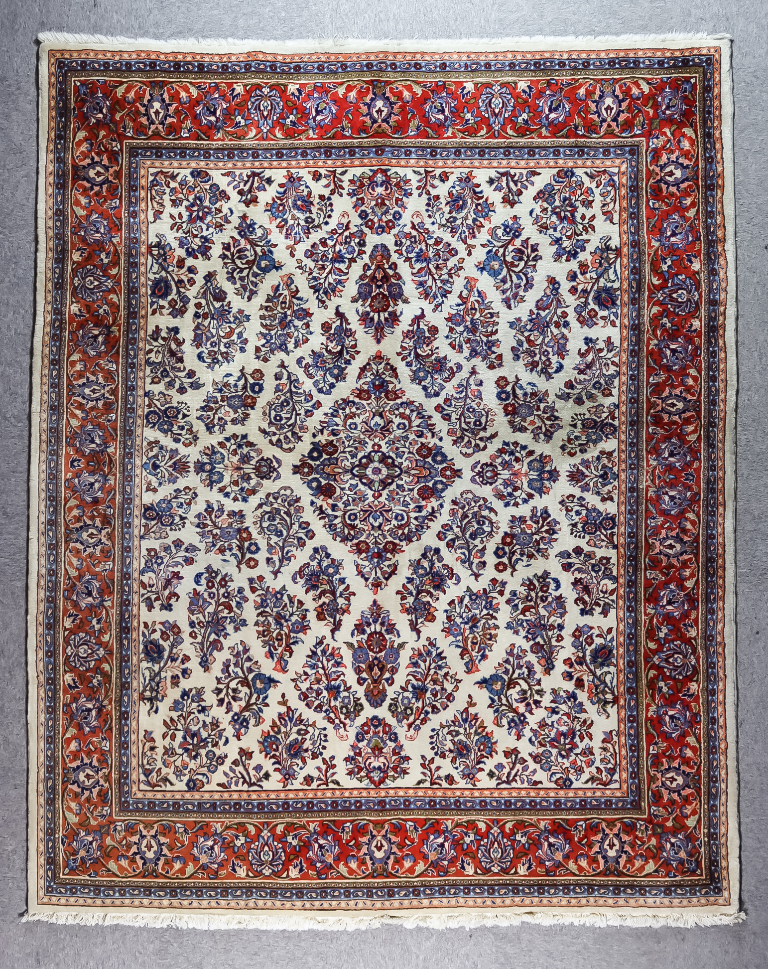 An Early 20th Century Kirman Carpet, woven in pastel colours with a central lozenge shaped