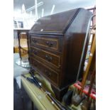 AN INLAID MHOGANY BUREAU WITH THREE LONG DRAWERS