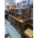 A MAHOGANY SIDEBOARD WITH RAISED BACK, HAVING CIRCULAR MIRROR, THREE CENTRE DRAWERS AND END