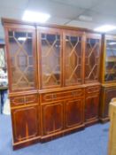 A LARGE MODERN YEWWOOD BREAKFRONT LIBRARY BOOKCASE, HAVING 4 GLAZED DOORS TO UPPER SECTION, THE BASE
