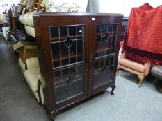 A DARK MAHOGANY DWARF BOOKCASE ENCLOSED BY TWO LEADED AND STAINED GLASS DOORS, ON STUMP CABRIOLE