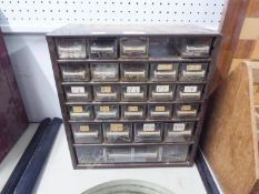 A METAL BENCH TOP CHEST WITH PLASTIC DRAWERS CONTAINING A QUANTITY OF NAILS AND SCREWS