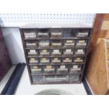 A METAL BENCH TOP CHEST WITH PLASTIC DRAWERS CONTAINING A QUANTITY OF NAILS AND SCREWS