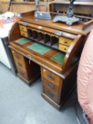 A SMALL  ROLL-TOP DESK, HAVING DOMED ROLLER SHUTTER GALLERY TOP WITH FITTED INTERIOR, RAISED ON TWIN