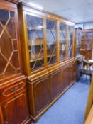 A MODERN YEWWOOD LIBRARY BOOKCASE WITH FOUR GLAZED DOORS TO TOP AND FOUR PANEL DOORS TO BASE (