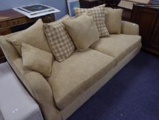 A LOUNGE SUITE COVERED IN OATMEAL COLOURED MOQUETTE, ON LOW WOODEN FEET, COMPRISING A LARGE SEMI-