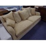 A LOUNGE SUITE COVERED IN OATMEAL COLOURED MOQUETTE, ON LOW WOODEN FEET, COMPRISING A LARGE SEMI-