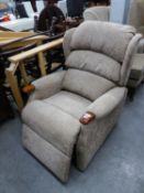 AN ELECTRONICALLY RECLINING LOUNGE CHAIR, IN SIMILAR FABRIC