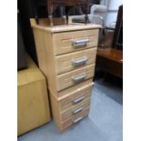 A PAIR OF PINE EFFECT THREE DRAWER BEDSIDE CHESTS WITH METAL BAR HANDLES