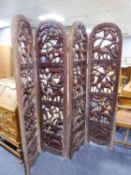 A HEAVY AFRICAN CARVED WOOD FOUR FOLD PRIVACY SCREEN