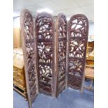 A HEAVY AFRICAN CARVED WOOD FOUR FOLD PRIVACY SCREEN