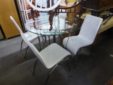 A DINING TABLE WITH CIRCULAR PLATE GLASS TOP ON THREE PAIRS OF BRIGHT METAL ?V? SHAPED SUPPORTS, THE