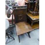 A GOTHIC CARVED OAK HALL CHAIR WITH 'X' SHAPED SUPPORTS