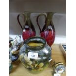 A PAIR OF GREEN AND MAROON GLAZED POTTERY TALL URNS AND A TWO HANDLED VASE (ONE HANDLE MISSING)