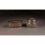 GEORGE V CUT GLASS DRESSING TABLE BOX WITH PLAIN SILVER PULL-OFF COVER, of oval form, glass chipped,
