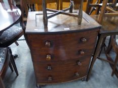AN ANTIQUE MAHOGANY COMMODE WITH FOUR FALSE DRAWERS AND BOWED FRONT