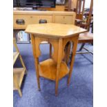 AN EARLY TWENTIETH CENTURY OAK HEXAGONAL OCCASIONAL TABLE WITH MOORESQUE ARCHES TO THE FRIEZE